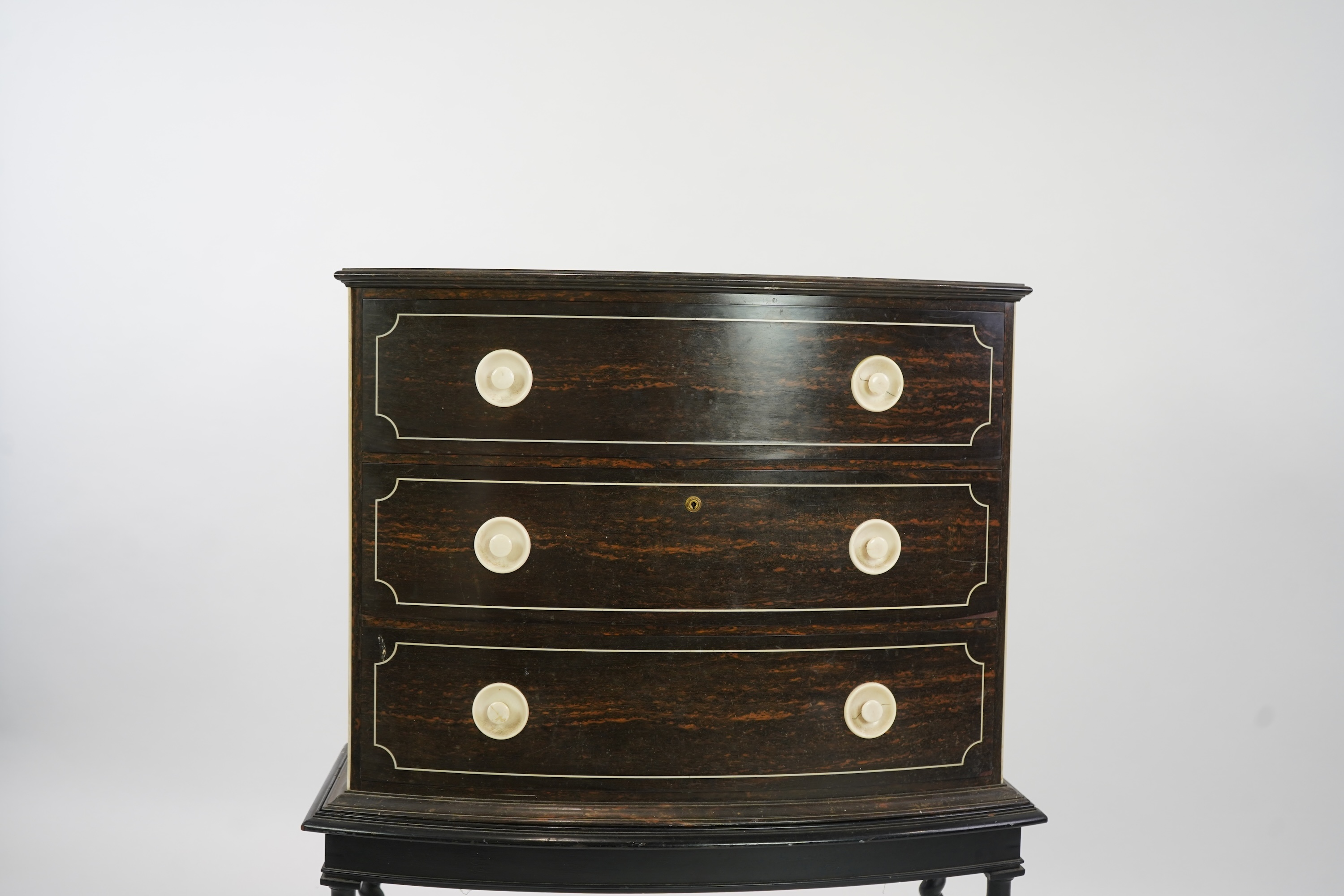 An early 20th century ivory mounted coromandel three drawer bowfront chest, stamped Callow of Mount Street, London